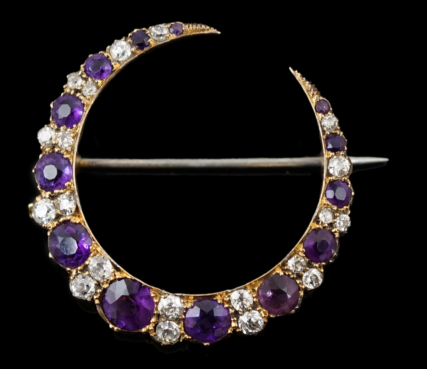 A late Victorian gold, graduated amethyst and diamond cluster set crescent brooch